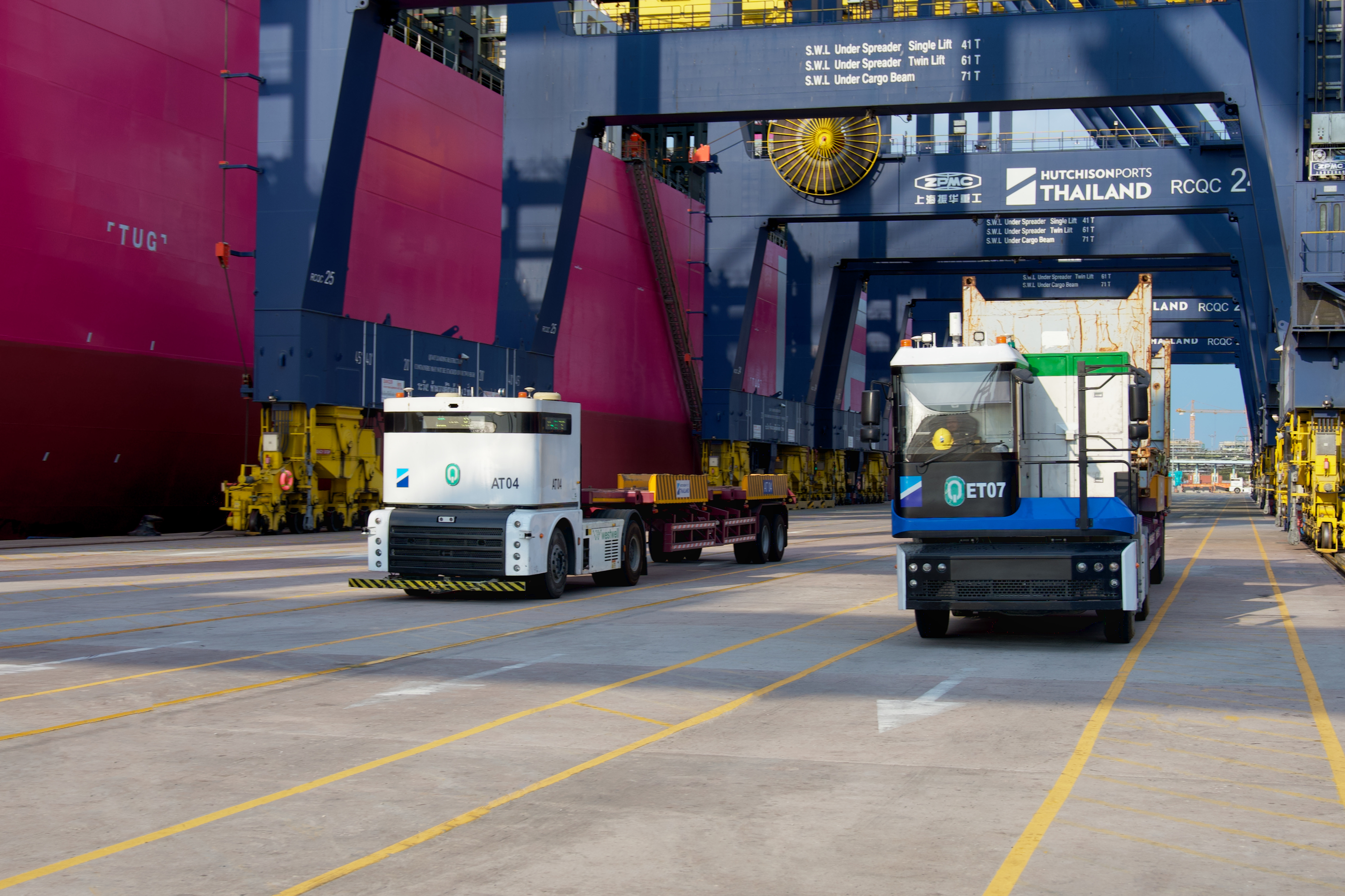 Mixed traffic operations between manned electric trucks and autonomous tractors at Laem Chabang Port, Thailand.