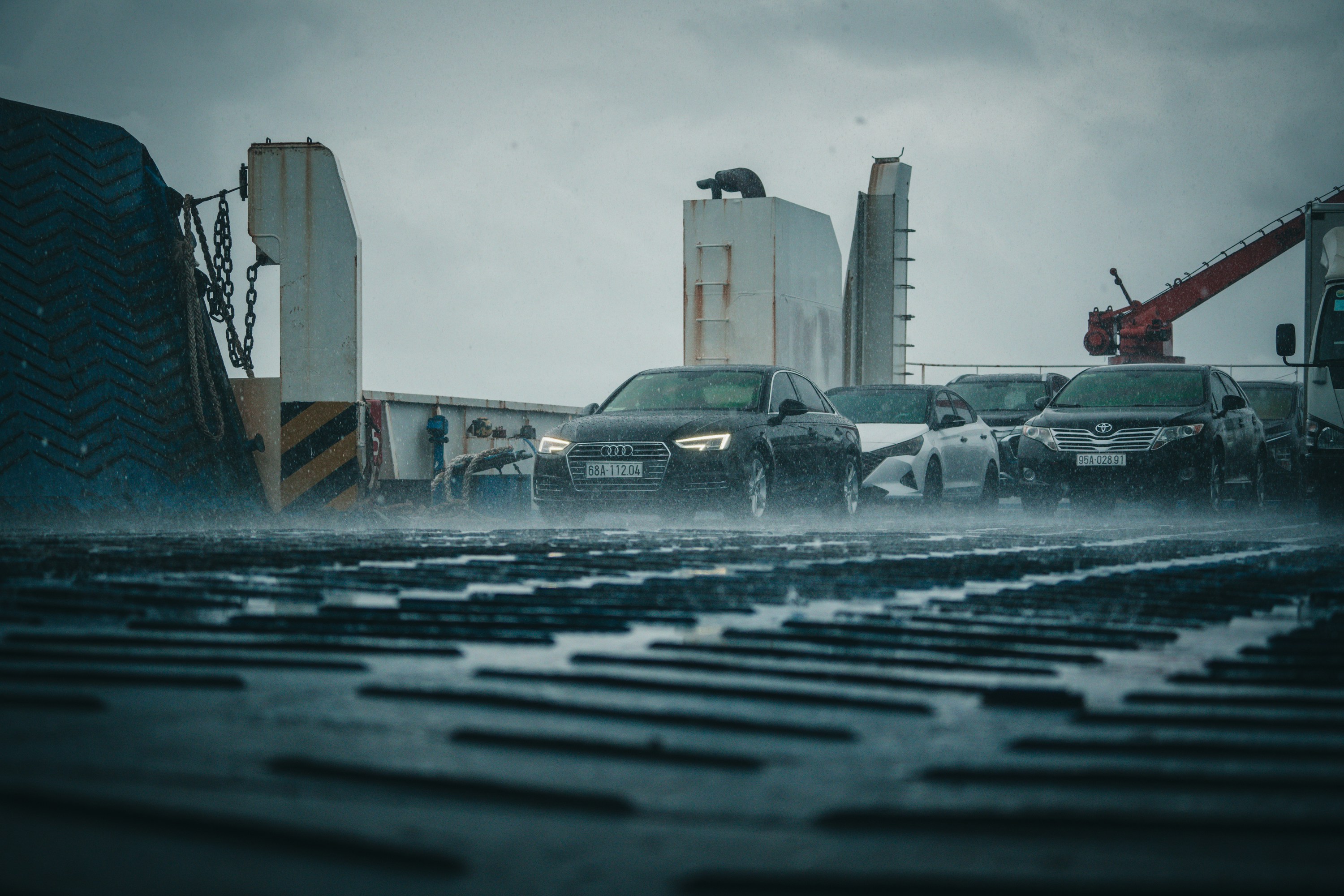 Ro-Ro terminal with wheeled vehicles lined up for unloading from a cargo vessel, showcasing efficient roll-on/roll-off vehicle handling operations.