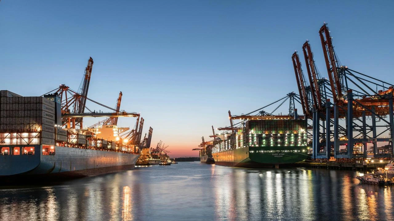 Container ships docked at a busy seaport terminal with cranes and cargo operations during sunset, showcasing global maritime logistics.